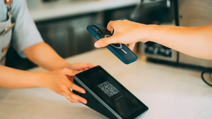 a close up shot of a person scanning a qr code