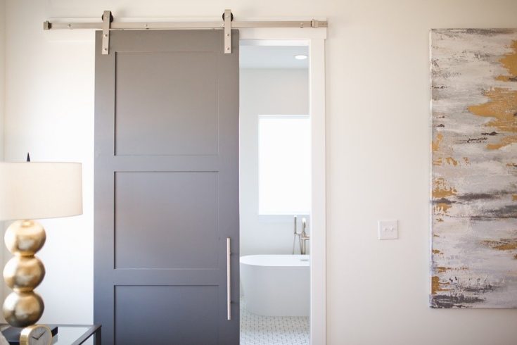 gray sliding barn door in bathroom