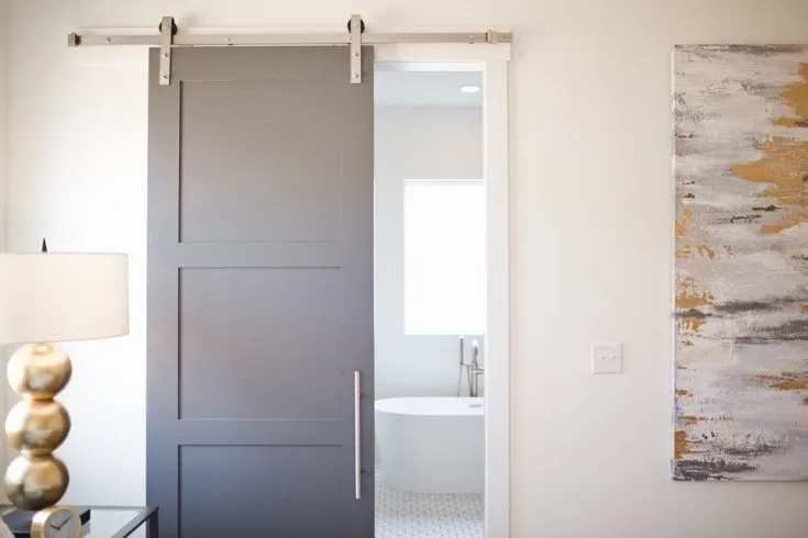 gray sliding barn door in bathroom