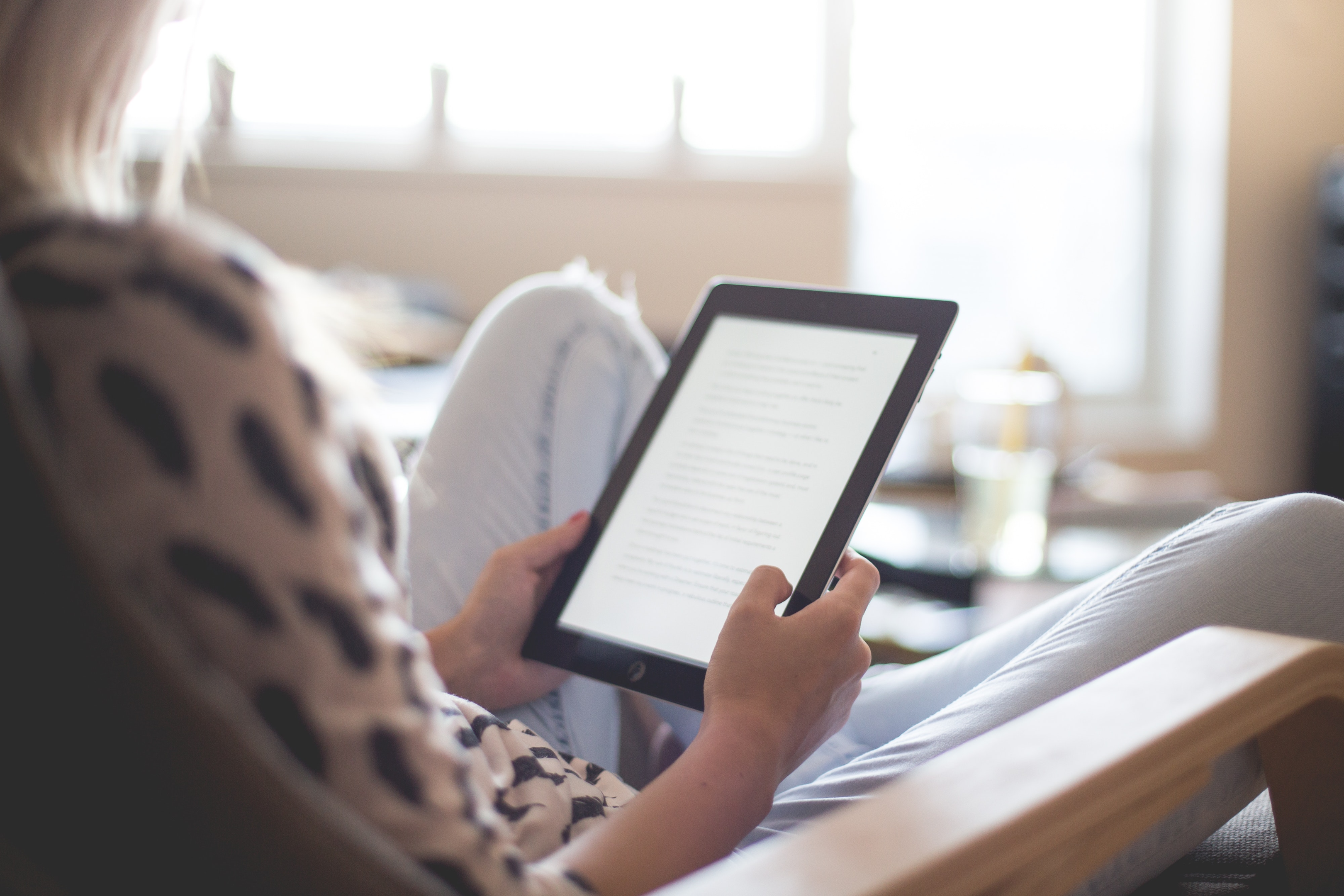 girl reading from her tablet