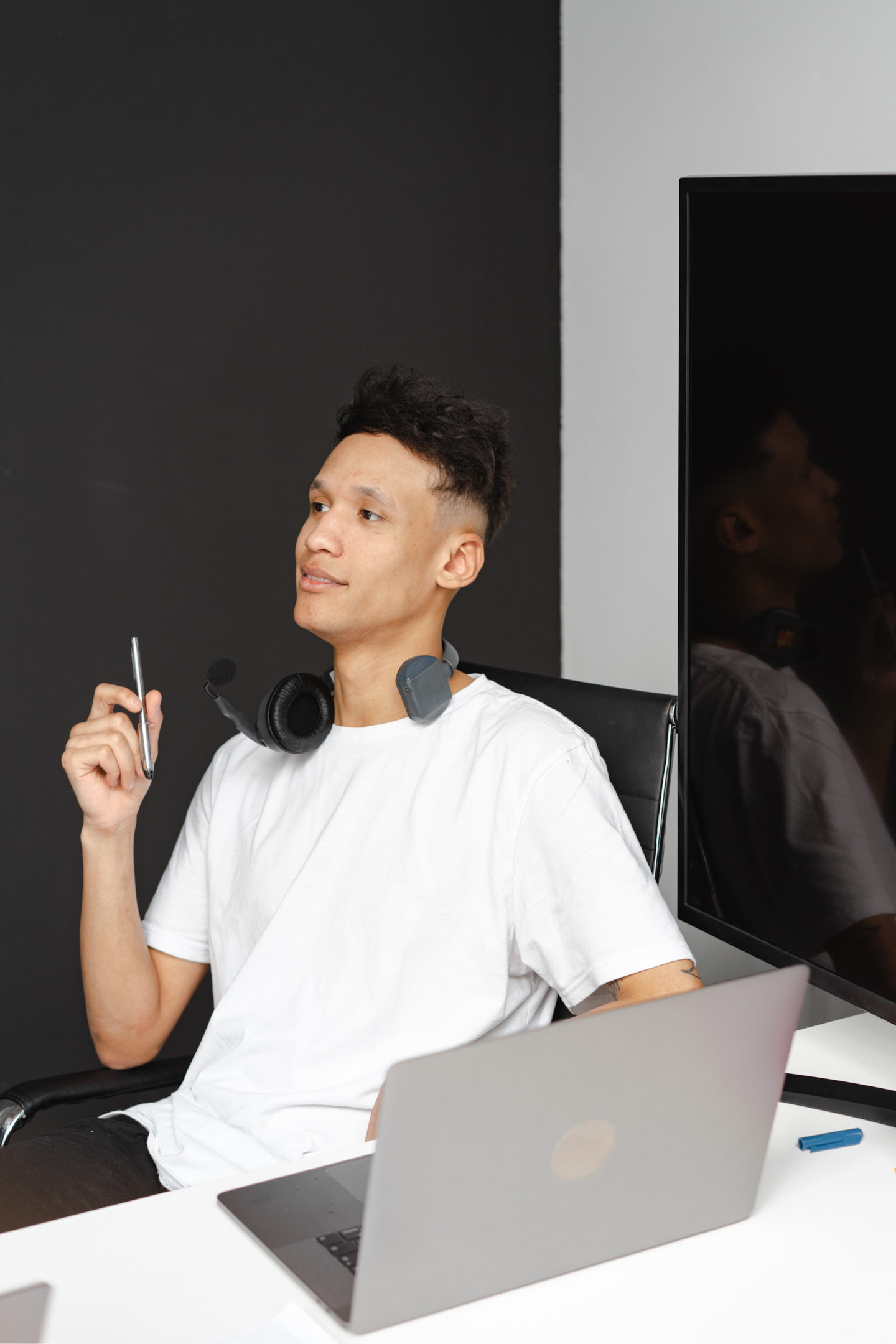 man with headphones working on a laptop