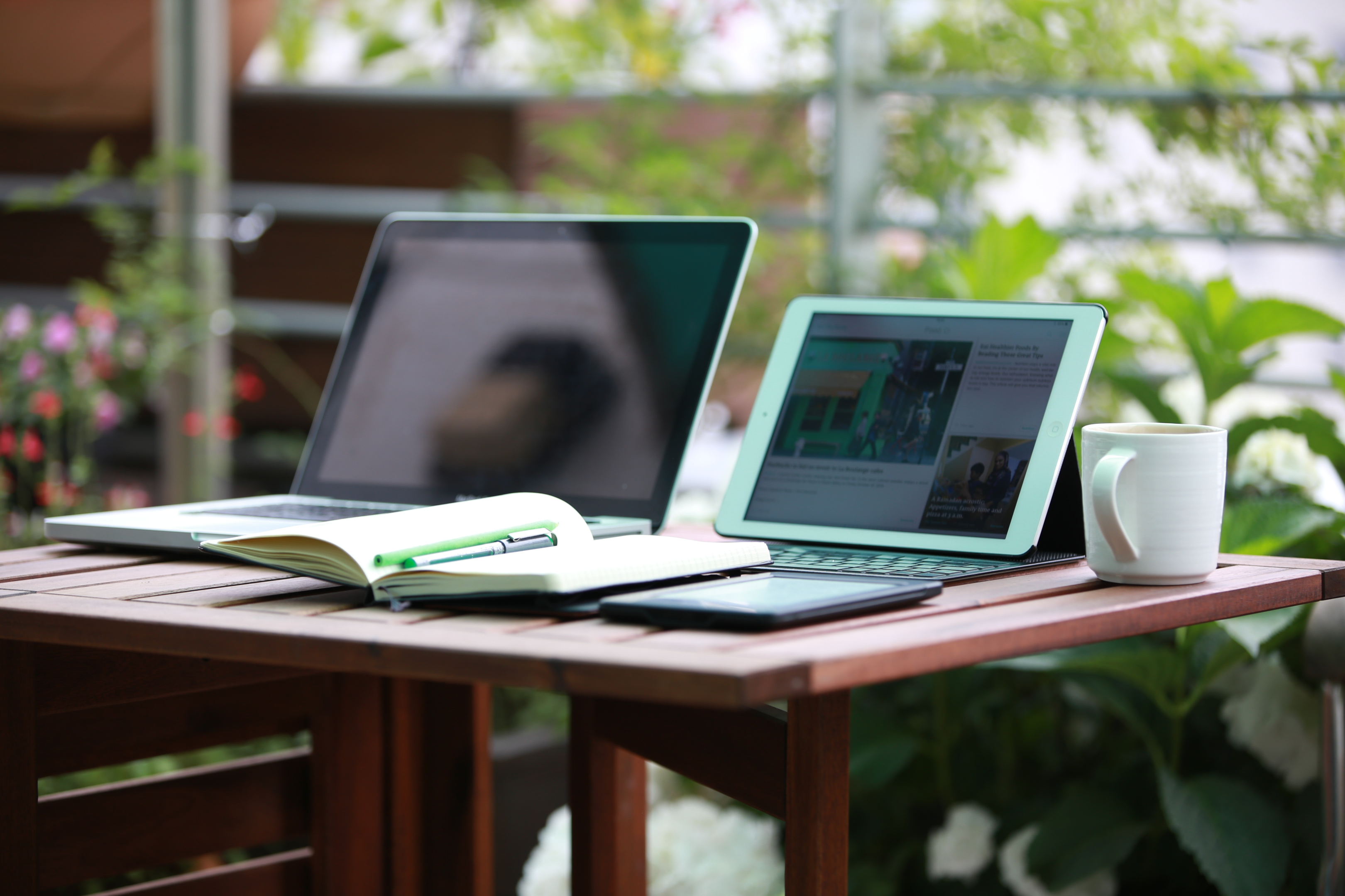 laptop and tablet sitting on top of a table