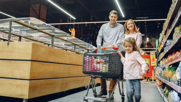 Family doing shopping in the grocery store using buy now pay later service