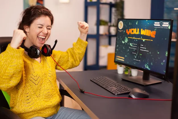 joyful player celebrates victory winning online video game