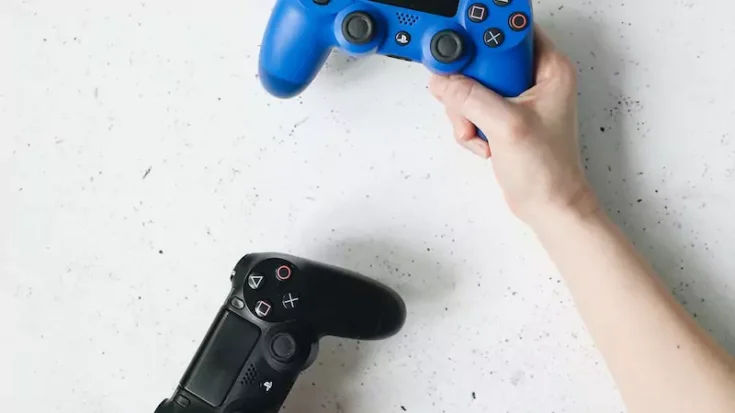 Person holding PS5 Controllers