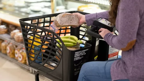 Woman in purple top and jeans in the Walmart store